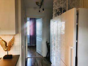 a kitchen with a door and a butterfly on the wall at Annex Artilleri in Visby