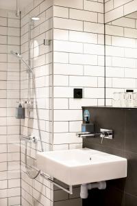a bathroom with a sink and a shower at Comfort Hotel Kista in Stockholm