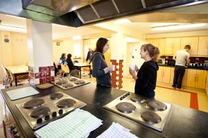 two women standing in a kitchen preparing food at Courtbrack Accommodation - Off Campus Accommodation in Limerick
