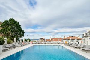 a large swimming pool with lounge chairs at R&eacute;sidence Vacances Bleues Le Grand Large in Biarritz