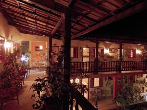 a building with a balcony with a table and chairs at Portal dos Borbas in Abraão
