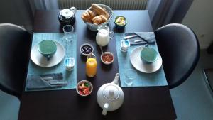 una mesa negra con platos y comida. en Hôtel Labat, en Orthez