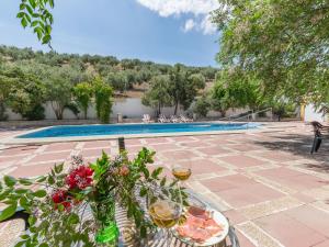 un patio con una mesa con copas de vino y una piscina en Modern Villa in Priego de Cordoba with Private Pool, en Priego de Córdoba