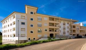 a large apartment building on the side of a street at Luxury 1 Bed Fully Equipped with Pool in Lagos