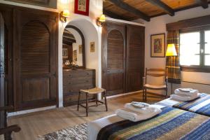 a bedroom with two beds and a dresser with towels at Tritonia in Gaios