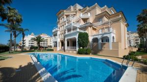 a large house with a swimming pool in front of it at Leo Rentals in Isla Canela
