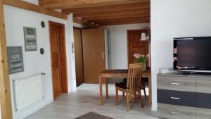 a dining room with a table and a tv at Gemütliches Apartment in Hattingen