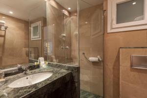 a bathroom with a sink and a glass shower at Canyelles Platja in Roses