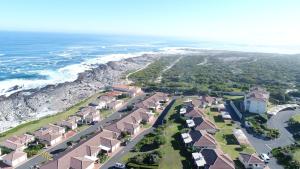 an aerial view of a beach with houses and the ocean at Hermanus Beach Club in Hermanus