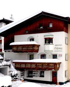 a large building with snow on top of it at Haus Arnold Schranz in Sankt Anton am Arlberg