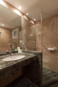 a bathroom with a sink and a glass shower at Canyelles Platja in Roses