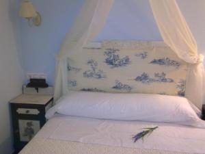 A bed or beds in a room at La Casa del Telar