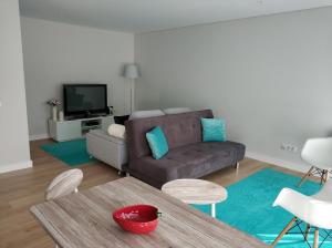 a living room with a couch and a table at Rafaelo's Apartment in Caldas da Rainha