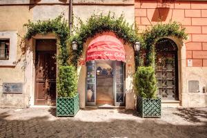 a building with two arches and a store front at Residenza San Calisto in Rome