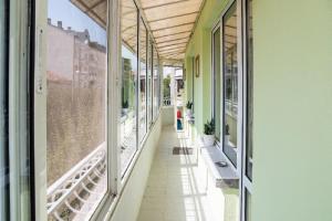 an empty corridor of a building with windows at Holiday Apartment on The Seaside, Burgas in Burgas