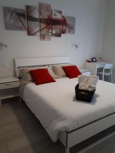 a bedroom with a large bed with red pillows at SoleLuna Fiera 6 Rooms in Bologna