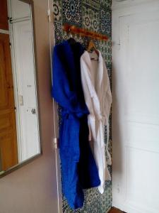 a room with a mirror and a bunch of clothes at Charme D Antan in Villers-Châtel