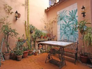 a room with a table and a bunch of potted plants at Terrace Apartment - Heart of Trastevere in Rome