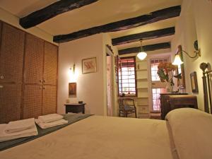 a bedroom with a bed and a table and windows at Terrace Apartment - Heart of Trastevere in Rome