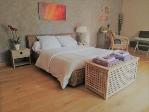 a bedroom with a large bed with towels on a table at La Goutadou in Cabannes