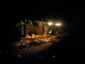 a backyard with a table and chairs at night at Linda Gorges du Caramy in Tourves