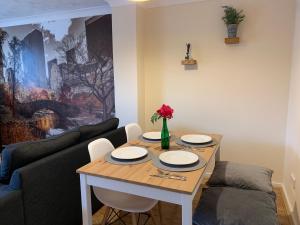 a living room with a table and a couch at Cosy Corner House in Kettering