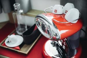 a close up of a red blender with white dishes on it at Mooser Hotel in Sankt Anton am Arlberg