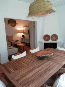 a wooden table with chairs in a living room at Dunes House in Carvalhal