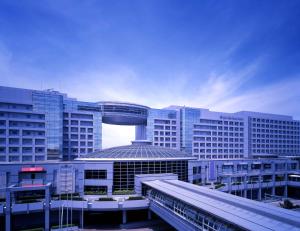 
a large building with a train on top of it at Hotel Nikko Kansai Airport - 3 mins walk to the airport in Izumi-Sano
