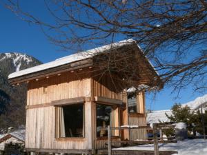 a small wooden house with snow on the roof at La Cubelette in Chamonix