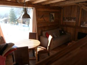 a living room with a couch and a table at La Cubelette in Chamonix