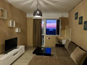 a living room with a couch and a tv at Bella Vista B&B in Ulcinj