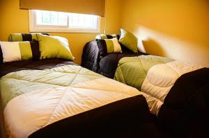 a bedroom with two beds and a window at La Isolina Club de Campo in Villa María +34 photos