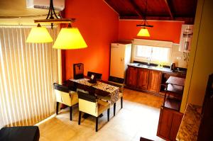 a kitchen with a table and chairs in a room at La Isolina Club de Campo in Villa María