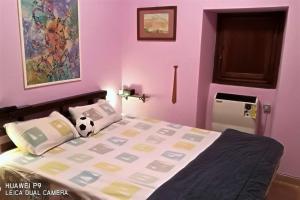 a bedroom with a bed with a soccer ball on it at Le meridiane in Piè la Costa