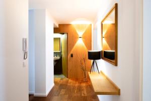 a hallway with a mirror on a wall next to a bathroom at Valschena Appartements in Brand