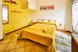 a bedroom with a bed with two yellow towels on it at Arcibaleno in Sabaudia