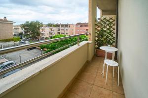 a balcony with a table and a view of a city at Arcibaleno in Sabaudia