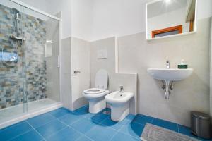 a bathroom with a toilet and a sink at Arcibaleno in Sabaudia +10 photos