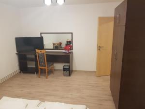 a desk with a computer and a chair in a room at Casa Lions in Timişoara