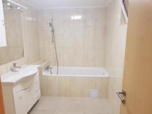 a bathroom with a bath tub and a sink at Casa Lions in Timişoara +44 photos