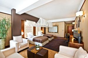 a hotel room with a bed and a tv at Grand Hotel Boutique in Rzeszów