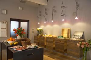 a kitchen with a counter with fruits and vegetables at Hotel Village in Aosta