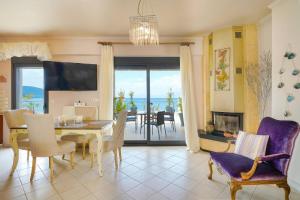 a dining room with a table and a view of the ocean at Lina's Sea View Apartments in Limenas