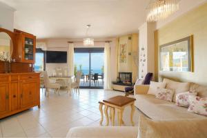 a living room with a couch and a table at Lina's Sea View Apartments in Limenas