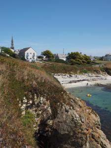 a view of a beach with people in the water at Le Roc'h Ar Mor in Ouessant