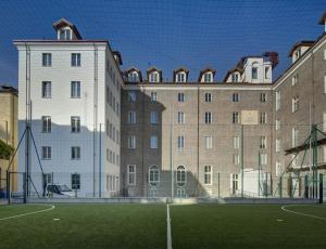 a tennis court in front of a large building at QUADRATO in Turin