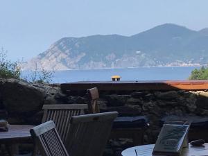 a table and chairs with a view of the water at il Magàn - Cinque Terre in Corniglia