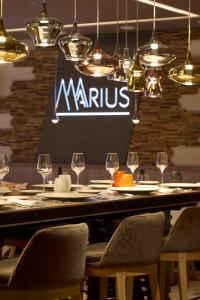 a table with chairs and wine glasses in a restaurant at Hotel Le Tremplin in Méribel +34 photos