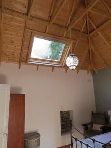 a room with a ceiling with a window and a bed at The Old House in Carrick-on-Suir